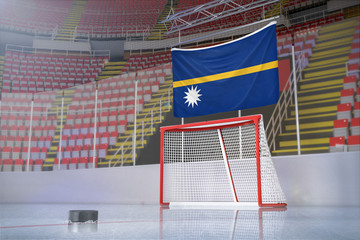 Flag of Nauru in hockey arena with puck and net