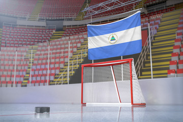 Flag of Nicaragua in hockey arena with puck and net
