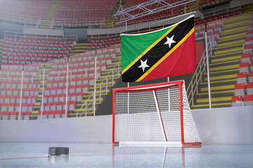 Flag of Saint Kitts and Nevis in hockey arena with puck and net