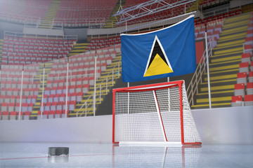 Flag of Saint Lucia in hockey arena with puck and net