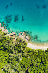 Fototapeta na wymiar View from above, stunning aerial view of a tropical coast bathed by a turquoise clear sea. Phuket, Thailand.