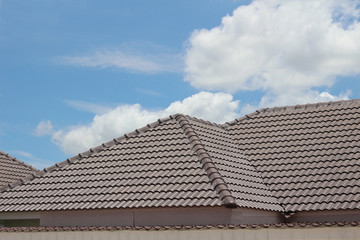 Fototapeta na wymiar tiles roof on new house with blue sky