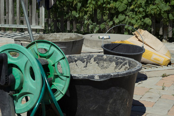 The hose reel and the solution tank stand on the tile floor