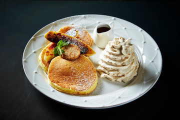 Pancakes with syrup and whipped cream