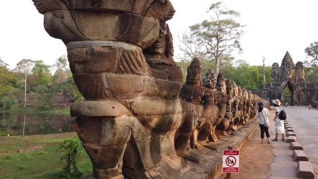 stone figures, "giants" of the Asuras (evil spirits) and Devas (good spirits) along the dam that crosses the moat at the Southern gate of Angkor Thom, among the Angkor complex of temples.