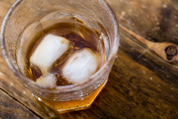 Top view of whiskey with ice in a glass 