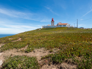 Fototapeta na wymiar SINTRA, PORTUGAL - May, 2019: Amazing landscape of Cabo da Roca in Portugal. Cabo da Roca (Cape Roca) is a cape which forms the westernmost extent of mainland Portugal and continental Europe.