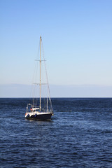 Fototapeta premium a yacht floats by the quiet sea