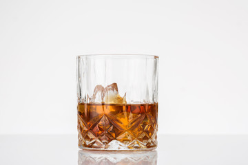 Glass of scotch whiskey on white background