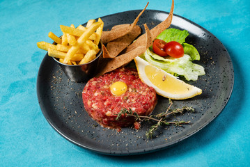 Beef tartare with egg yolk and french fries