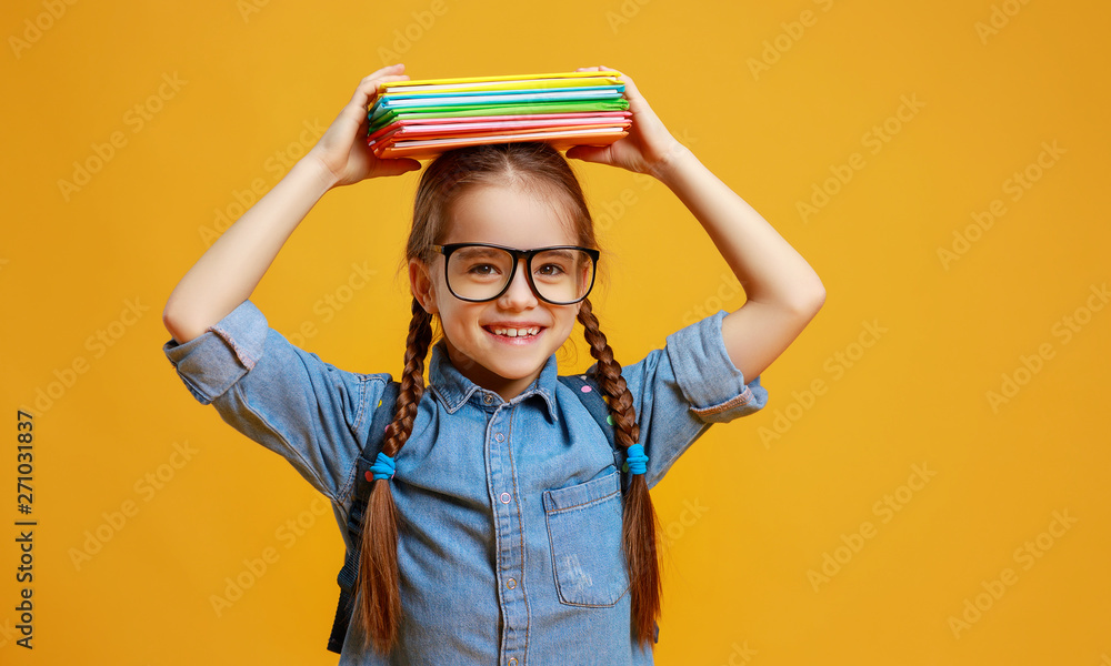 Wall mural funny child school girl girl on yellow background .