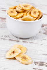 Banana chips in bowl as natural snack for dessert
