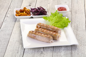 Grilled sausages served mushrooms and cabbage