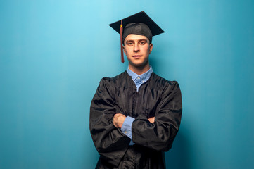 Male student graduate isolated on blue background