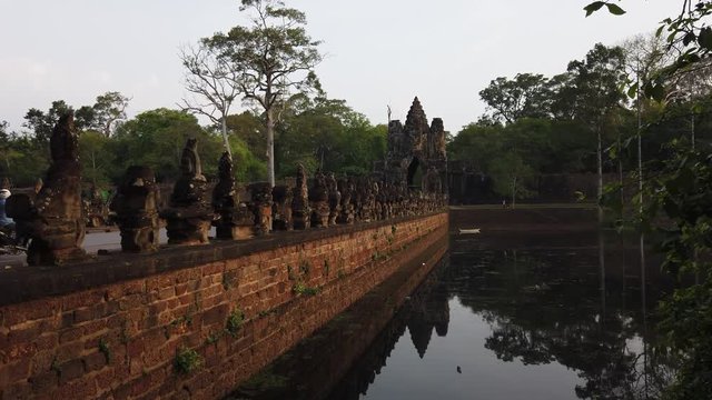 stone figures of &ldquo;giants&rdquo; of asuras (evil spirits) and devas (good spirits) along a dam crossing the moat at the south gate of Angkor Thom, among the complex of temples of Angkor