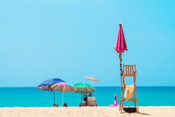 People sunbathing and relaxing on beach chairs. Sea view and blue sky. Summer background -  Image