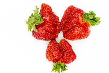 Strawberry. Imperfect Fresh Organic Fruit Closeup. Healthy Green Vegetarian Nutrition. Whole Vitamin Breakfast Ingredient. Ugly Non Ideal but Delicious Summer agriculture Berry.