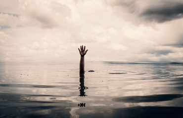 Hand of man want to helping after drown in the lake