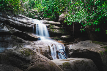 Waterfall flowing through rocks in rainy season.