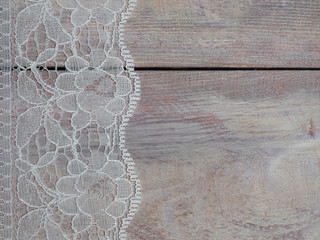 White laces on a brown wooden background vertically in row