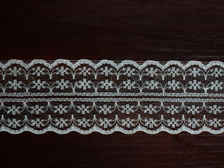 White laces on a brown wooden background