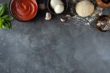Ingredients for traditional Italian pizza Margherita with tomato sauce, Mozzarella cheese, basil on...