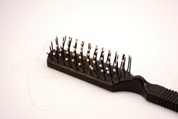 comb with hair close up on a white background