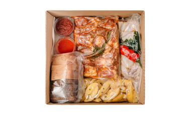 Collection of take away kraft boxes with  different bbq  food. Set of containers with everyday meals - meat, vegetables and law fat snacks on white background, top view. 