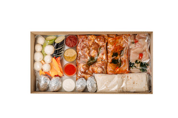 Collection of take away kraft boxes with  different bbq  food. Set of containers with everyday meals - meat, vegetables and law fat snacks on white background, top view. 
