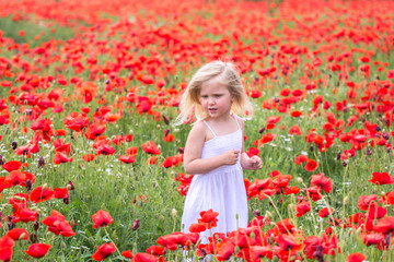 Naklejka na ściany i meble happy girl in a flower field