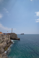 ancient buildings on the rocky shore on a bright sunny day.