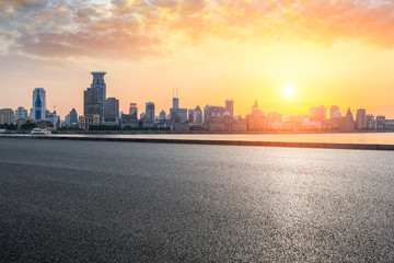 Fototapeta premium Shanghai bund city skyline and empty asphalt highway at sunset