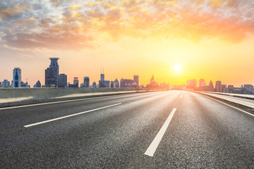 Shanghai bund city skyline and empty asphalt highway at sunset