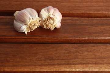 head of garlic on wooden background