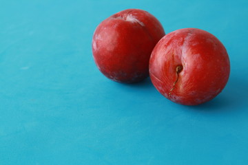Delicious plums in colorful background