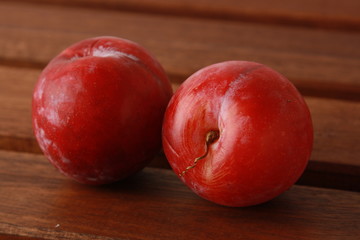 Fototapeta na wymiar Delicious plums on wooden background