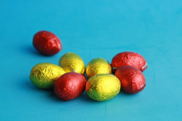 chocolate easter eggs, wrapped in yellow and red paper