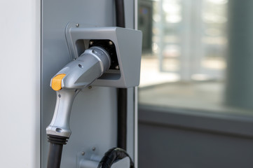 closeup charger battery for electric car with soft-focus and over light in the background