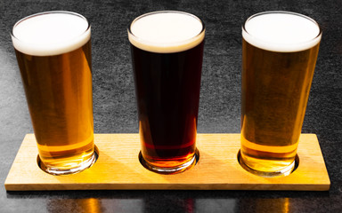 Three craft ales in Cartmel, Cumbria, lined up in a beer garden in the summer sun