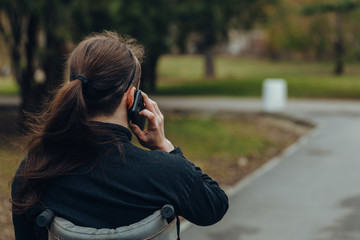 Portrait of a happy man on a wheelchair in a park