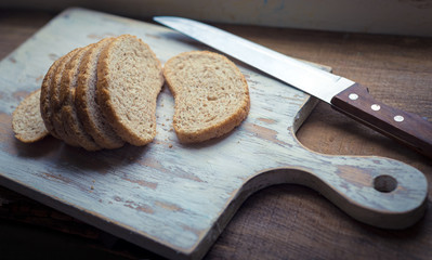 Homemade healthy whole grain bread on rustic wooden background