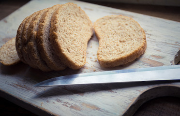 Homemade healthy whole grain bread on rustic wooden background