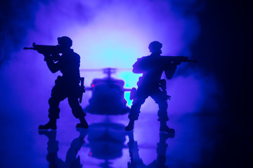 Fototapeta premium Artwork decoration. Soldiers in the desert during the military operation with combat helicopter or Helicopter assault special forces.