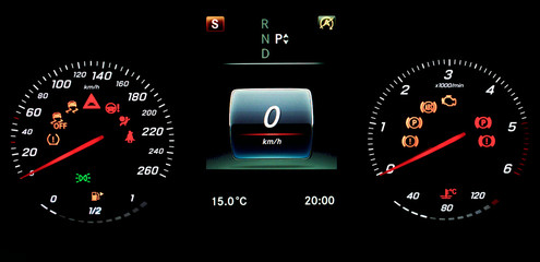 A car instrument panel with speedometer, tachometer, odometer, fuel gauge, car's temperature gauge, TPMS icon, check engine, airbag and brake system icons. A photo on isolated background.