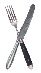 Beautiful old vintage crossed knife and fork isolated on white background. Top view. Retro silverware.