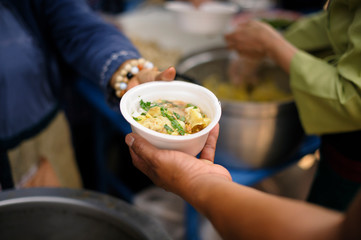 The concept of feeding : The hands of the poor receive food from the hands of the humane : Helping Feed the Poor