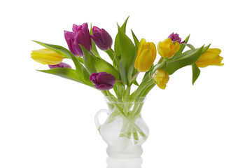 Bouquet of colorful tulips in a jug isolated on white background