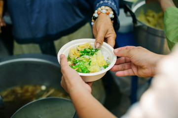 The concept of feeding : The hands of the poor receive food from the hands of the humane : Helping Feed the Poor
