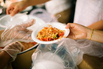 the concept of social inequality : Donating food to beggars to alleviate hunger : The hands of the poor receive food from the hands of the humane
