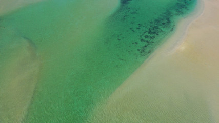Aerial drone bird's eye view photo of tropical caribbean paradise bay and lagoon with white sandy beach and turquoise clear sea